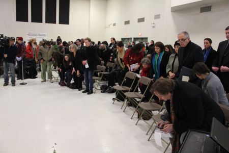 As everyone stands to honour the missing and murdered women, one man in the official Commission seating area focuses on his blackberry. Photo: Tami Starlight 