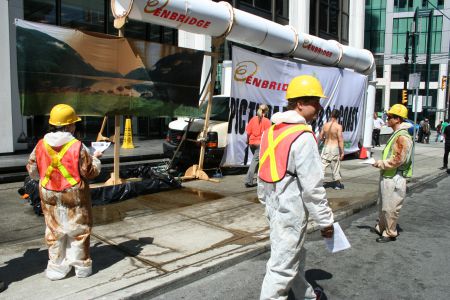 Oil soaked "mock Enbridge workers" 
