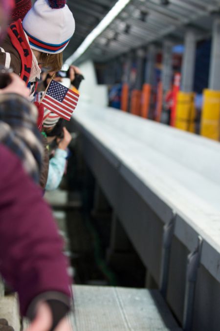 Fans watch lugers pass by the point where Georgian luge slider Nodar Kumaritashvili died on Opening day of the Olympics. Photo: Kevin Pedraja (CC)