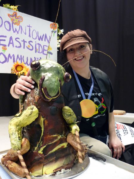 DTES resident and cockroach cake creator Rosanne Gervais poses at the closing ceremonies with her sweet delight which took 100 hours to make and uses 11 pounds of butter // Esther Hsieh