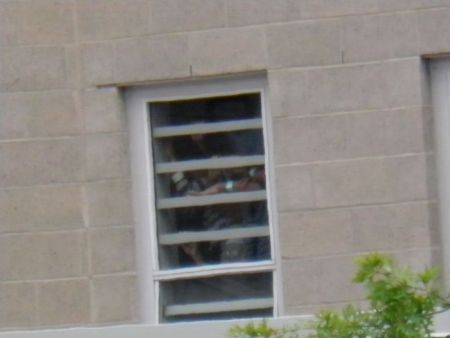 Children inside the Center peer out the window, trying to get a look through the bars at all the people that had come to support them.