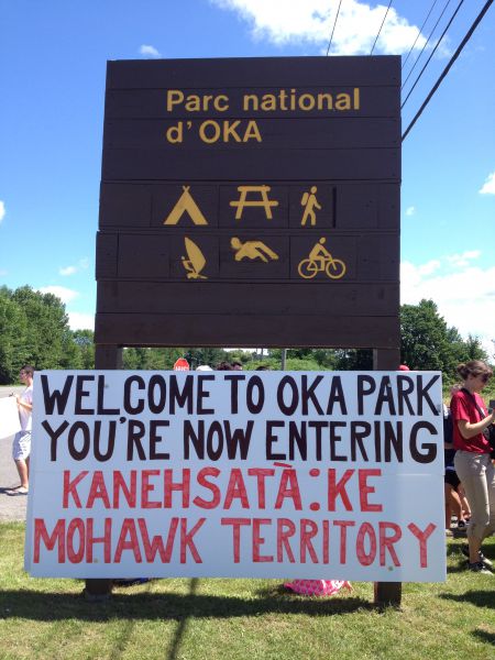 A sign at the entrance to Parc Nationale d’Oka, where Kanien’kehá:ka artifacts are being excavated by archaeologists without community consent. Photo by Ellen Gabriel. A sign at the entrance to Parc Nationale d’Oka, where Kanien’kehá:ka artifacts are being excavated by archaeologists without community consent. Photo by Ellen Gabriel.