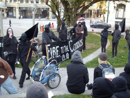 Anarchists display their banners to the assembled crowd at Victory Square.. Anarchists display their banners to the assembled crowd at Victory Square..