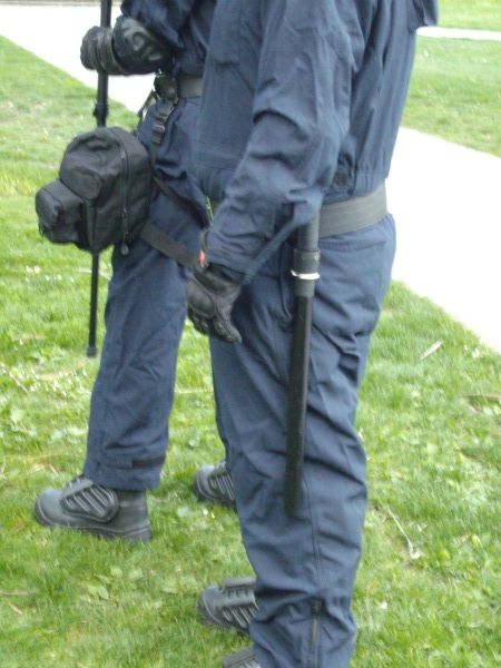 This second deployment saw PSU members wearing coveralls with body armour, 3 foot long riot batons, and gas masks strapped to their legs. This second deployment saw PSU members wearing coveralls with body armour, 3 foot long riot batons, and gas masks strapped to their legs.
