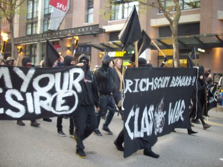 Members of the black bloc and their banners. Members of the black bloc and their banners.