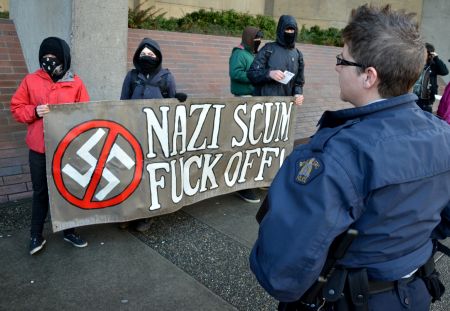 This group handed out pamphlets with pictures of the accused and of lesser-known Nazi symbols. <i>murray bush - flux photo</i>