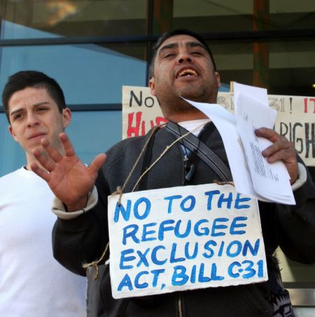 Oswaldo Godoy, from the organizing committee of the Movement to Protect the Human Rights of Refugees and Immigrants, addresses a rally against Bill C-31. Vancouver, April 4, 2012. Photo: Sandra Cuffe