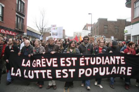 Protesters march in Montreal, "The student strike is a popular struggle" reads the banner.