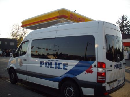 Cops at first parked their riot squad van in one of the Shell station driveways.