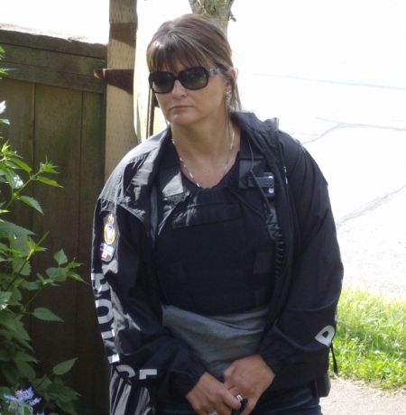 Unidentifed female cop also present during June 3 raid.