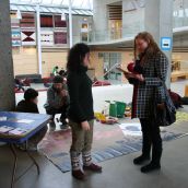 Alejandra connects with SFU student and hands her information