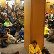 Overflow crowd listening from the next room 