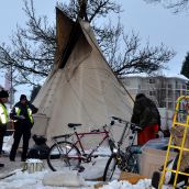 Police pressing campers to leave parking lot site 