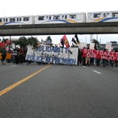 Rally heads down Clark to 1st & onto downtown (skytrain runs overhead)