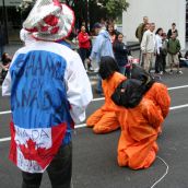 The unknown prisoners are forced to kneel once more