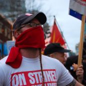 Protester stands in front of the police line at BC Place