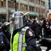 Riot Police attack the crowd with clubs