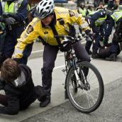 Photographer is thrown on the ground by police