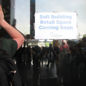 Having the doors to the hall shut on them, activists hammered on the glass until the open house was cancelled