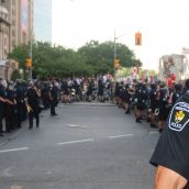 Cops surround 1 umbrella and 1 placard