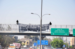 Banner drop outside the "Centre for Justice," Santiago in solidarity