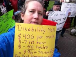 housing costs, low assistance rates cause homelessness in BC (pictured Roslyn Cassells at Inclusion BC demo)